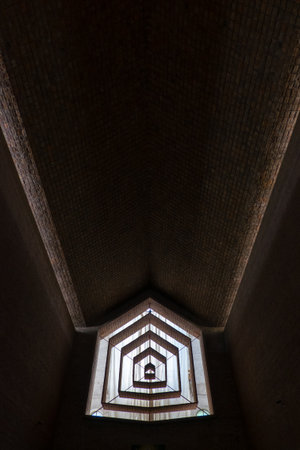 A dark room with a window that is open. The window is in the middle of the room and is surrounded by...