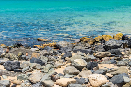 Scenic rocky shoreline with clear turquoise waters and a sunny horizon.の写真素材
