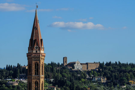 Florence skyline with historic architecture and greenery against clear blue skyの写真素材
