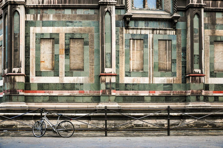 Vintage bicycle by historic Florentine building with intricate detailsの写真素材