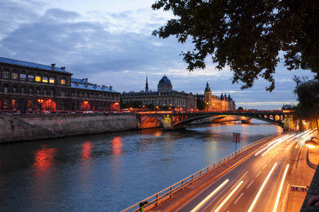 Paris, Ille de France, France. September 16, 2024: Evening view of the Seine River with light trails and historic buildings in Paris, Franceの写真素材