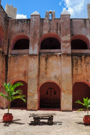 Historic Valladolid courtyard with rustic architecture and tropical plantsの写真素材