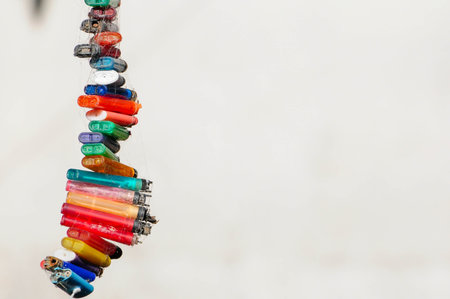 Vibrant display of colorful cylindrical beads on plain background.の写真素材