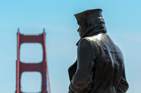 San Francisco, CA, USA. April 24, 2012: Bronze statue of a sailor overlooking the Golden Gate Bridge in San Francisco.の写真素材