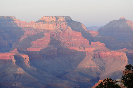 Grand Canyon's layered rocks at sunset with rich reds and orangesの写真素材