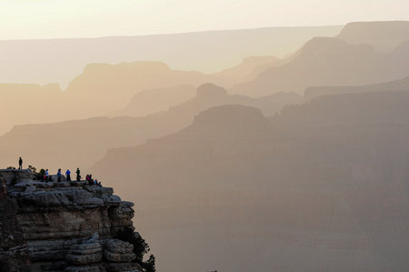 Visitors admire sunset over Grand Canyon's majestic formationsの写真素材