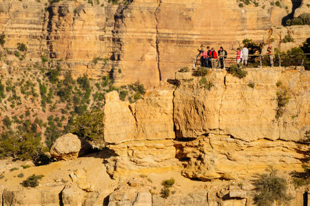 Grand Canyon, Arizona, USA. May 01, 2012: Tourists enjoying the scenic view from the Grand Canyon's rocky edge.の写真素材