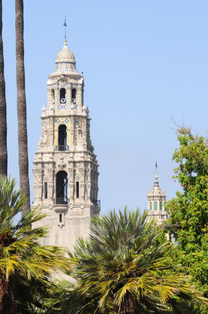 Historic towers rise amidst lush greenery in sunny Balboa Park, San Diego.の写真素材