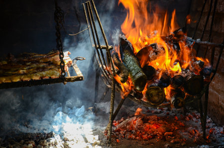 Rustic barbecue with flames and cozy ambiance for traditional outdoor grillingの写真素材