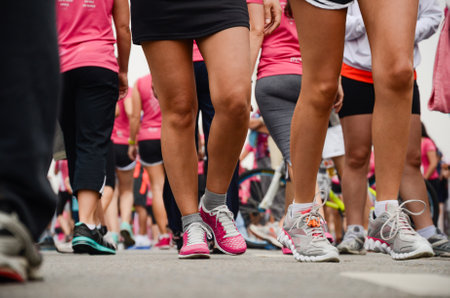 Diverse group at charity marathon in colorful athletic gear, ready to start.の写真素材