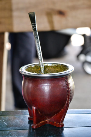 Mate gourd and straw on wood surface, capturing Uruguayan culture essenceの写真素材