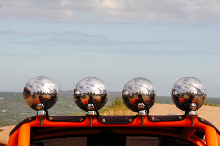 Chrome lights reflect seaside view on vintage car in Punta del Este, Uruguayの写真素材