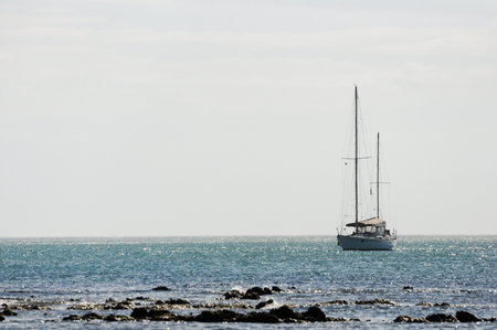 Sailboat on tranquil ocean with clear horizon in Punta Del Este Uruguayの写真素材