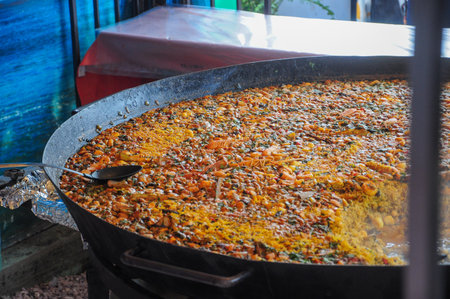 Large pan of colorful traditional seafood paella with fresh ingredientsの写真素材