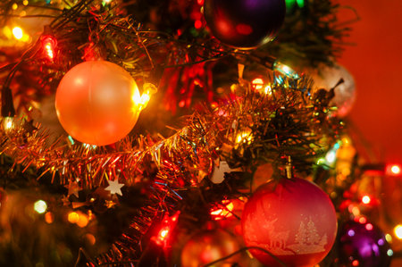 Close-up of decorated Christmas tree with ornaments and twinkling lightsの写真素材