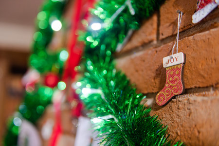 Details of the Christmas decoration with a small boot of Santa Calus and the word "Joy", on a fireplaceの写真素材