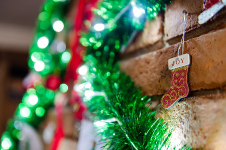 Details of the Christmas decoration with a small boot of Santa Calus and the word "Joy", on a fireplaceの写真素材