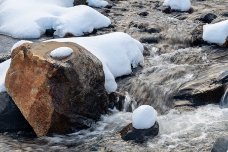 A rock is in the middle of a stream of water.の写真素材
