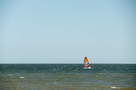 Windsurfer gliding over tranquil ocean waves near Piriapolis, Uruguayの写真素材