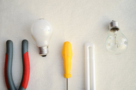 Tools and light bulbs on white background symbolizing creativity and innovationの写真素材