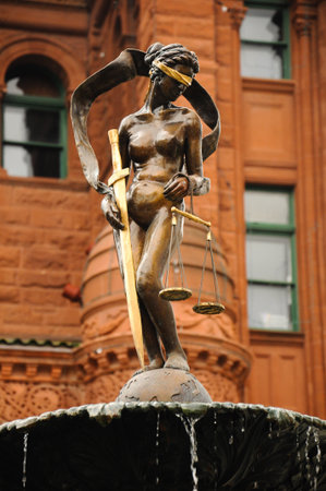 San Antonio, Texas, USA. March 16, 2013: Lady Justice statue in front of San Antonio City Hall during St. Patrick's Day celebrations.の写真素材
