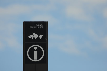 Sydney Opera House symbol on info sign against blue sky backgroundの写真素材