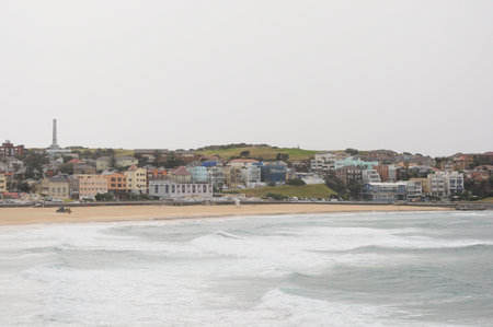 Bondi Beach, gentle waves, cloudy day, colorful beachfront buildingsの写真素材