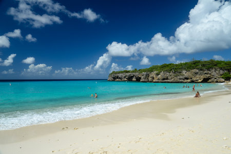 Willemstad, Curazao, Netherland Antilles. November 26, 2013: Tourists enjoy a sunny day at a picturesque beach in Curacao, Netherland Antilles.の写真素材
