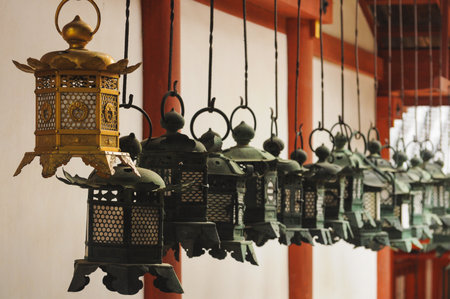 Bronze lanterns line a temple corridor in Nara, Japanの写真素材