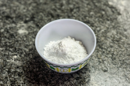 Bowl of flour on granite countertop for homemade bakingの写真素材