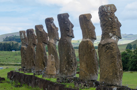 Moai statues at Ahu Akivi, Easter Island with lush green hillsの写真素材