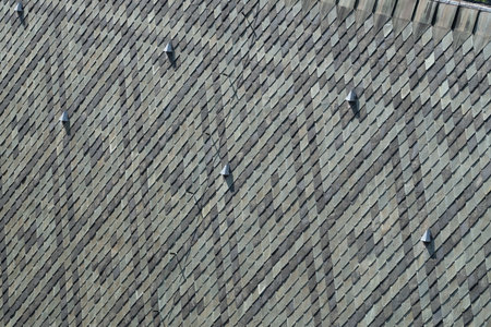 Geometric rooftop pattern with textured shingles in natural lightの写真素材