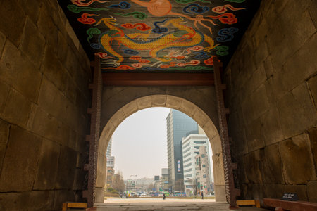 Historic Seoul gate with vibrant dragon artwork ceilingの写真素材