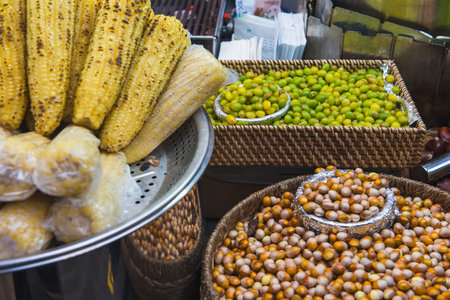 Grilled Corn and Fresh Nuts at Bustling Street Marketの写真素材