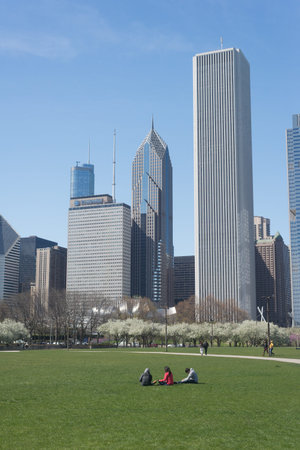Chicago, Illinois, USA - April 22, 2017: Chicago skyline backdrop for people relax on grass in the park, Illinoisのeditorial素材