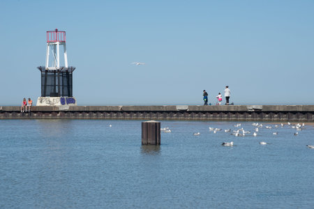 Chicago, Illinois, USA - April 23, 2017: North Avenue Beach Pier: Lighthouse, People and Gulls on a Summer Dayのeditorial素材