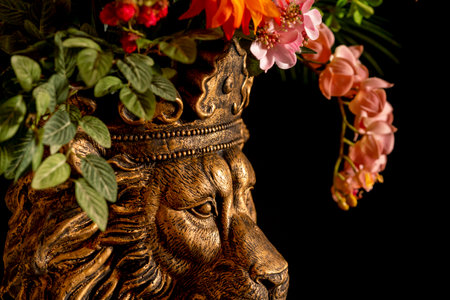 Wooden lion head with flowers in a vase on a black backgroundの写真素材