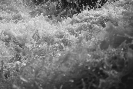 abstract black and white background of water splashes in the riverの写真素材