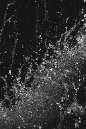 Water splashes on a black background. Closeup. Monochrome.の写真素材