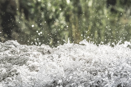 Water splashes on nature background, close up. Shallow depth of field.の写真素材