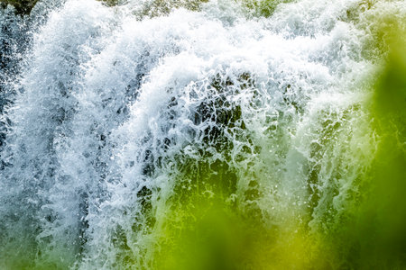 Close up of a waterfall in the forest on a sunny day.の写真素材