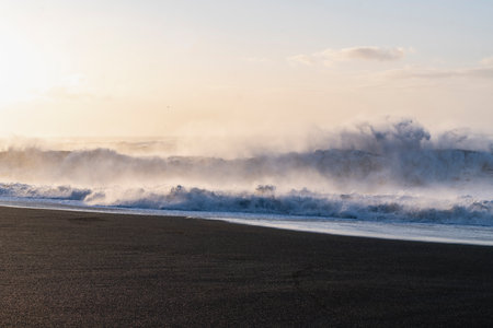 Waves breaking on black sand beach in Reynisfjara, Icelandの写真素材