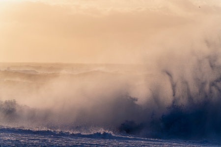 Beautiful winter landscape with big wave on the beach at sunset.の写真素材