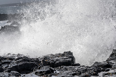 Big wave breaking on the rocks. Iceland. Tenerife.