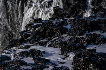 Icelandic waterfall in winter with snow and icelandic natureの写真素材