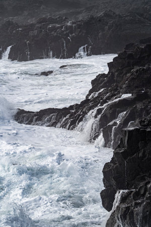 Waves breaking on the rocks in the Atlantic Ocean in Canary Islandsの写真素材