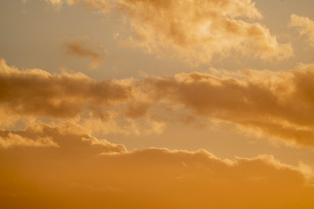 Sunset sky with orange clouds. Nature background. Toned.の写真素材