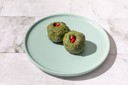 Pkhali from spinach with pomegranate seeds and pomegranate seedsの写真素材