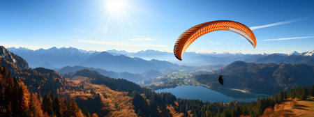Paraglider in the mountains. Panoramic view background and copy spaceの素材