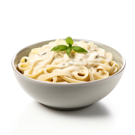 Pasta with cream sauce in a bowl, isolated on white backgroundの素材